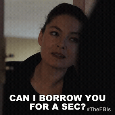 A Woman Says " Can I Borrow You For A Sec " While Leaning Against A Wall GIF