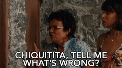 A Woman Says " Chiquita Tell Me What 'S Wrong " While Standing Next To Another Woman GIF