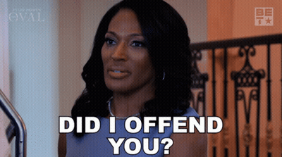 A Woman Says Did I Offend You While Standing In Front Of A Railing GIF
