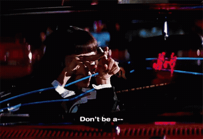 A Woman Says " Don 'T Be A " In Front Of A Blurry Background GIF