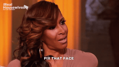 A Woman Says Fix That Face In Front Of A Real Housewives Sign GIF