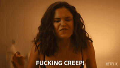 A Woman Says Fucking Creep While Holding A Small Object GIF