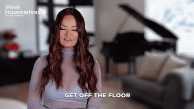 A Woman Says Get Off The Floor While Sitting In A Living Room GIF