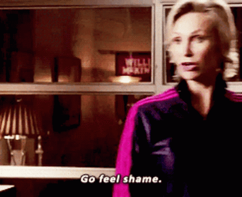 A Woman Says Go Feel Shame While Standing In Front Of A Window GIF