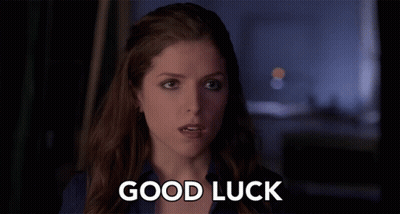 A Woman Says " Good Luck " In Front Of A Dark Background GIF