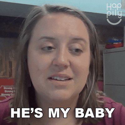 A Woman Says He 'S My Baby In Front Of A Sign GIF