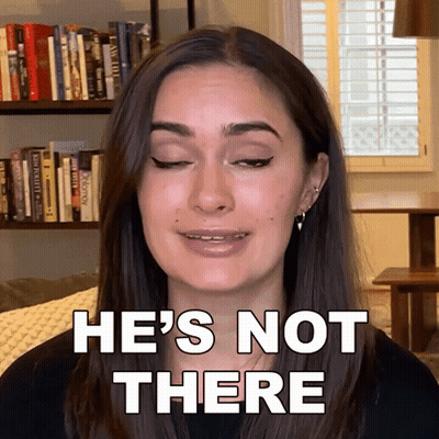 A Woman Says He 'S Not There In Front Of A Book Shelf GIF