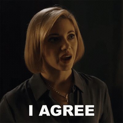 A Woman Says I Agree In Front Of A Dark Background GIF