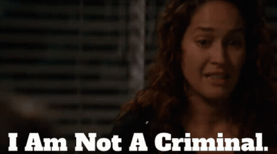 A Woman Says " I Am Not A Criminal " In Front Of A Dark Background GIF