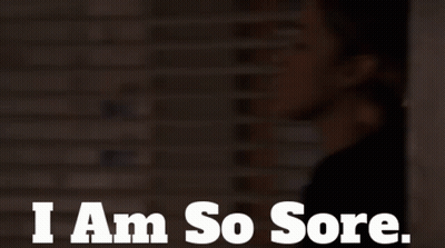 A Woman Says I Am So Sore In Front Of A Brick Wall GIF