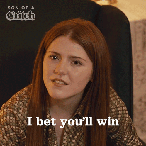 A Woman Says I Bet You 'Ll Win In Front Of A Poster For Son Of A Grifch GIF