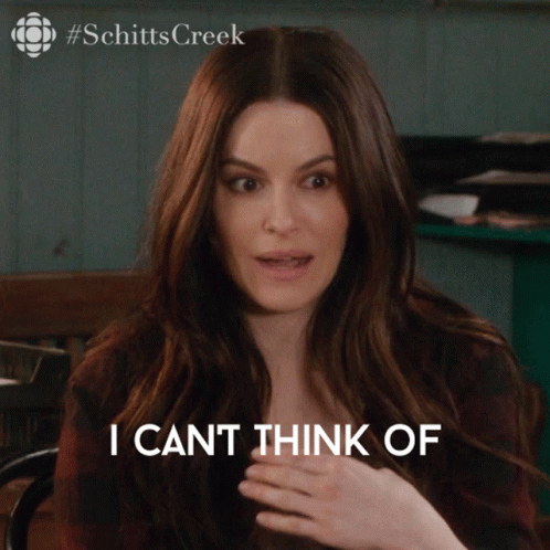 A Woman Says I Can 'T Think Of While Sitting At A Table GIF