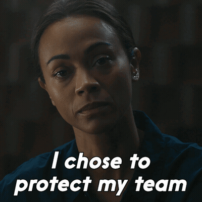 A Woman Says " I Chose To Protect My Team " In A Dark Room GIF