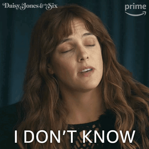 A Woman Says I Do N't Know In Front Of A Poster For Daisy Jones & The Six GIF
