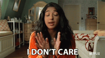 A Woman Says I Don 'T Care In Front Of A Couch GIF