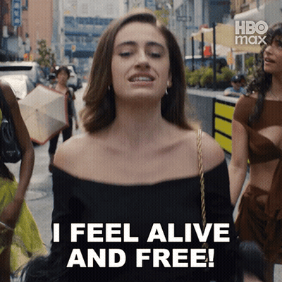 A Woman Says I Feel Alive And Free While Walking Down A City Street GIF