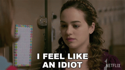A Woman Says I Feel Like An Idiot In Front Of A Netflix Sign GIF