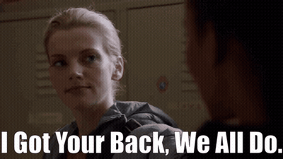 A Woman Says " I Got Your Back We All Do " In Front Of A Locker GIF