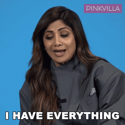 A Woman Says I Have Everything In Front Of A Blue Background GIF
