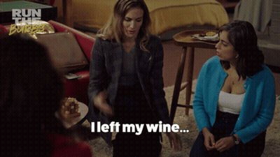 A Woman Says " I Left My Wine " While Sitting In A Living Room GIF