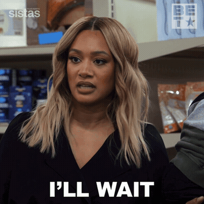 A Woman Says I 'Ll Wait In Front Of A Shelf GIF