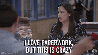 A Woman Says I Love Paperwork But This Is Crazy In Front Of A Pile Of Papers GIF