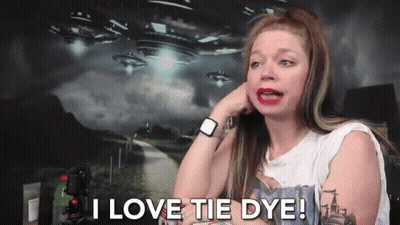 A Woman Says I Love Tie Dye In Front Of A Picture Of Aliens GIF