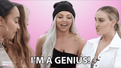 a woman says " i 'm a genius " while standing next to two other women