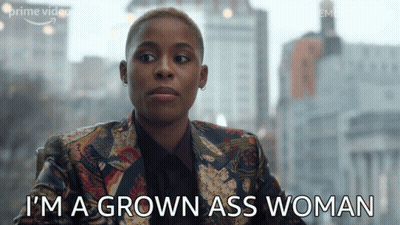 A Woman Says " I 'M A Grown Ass Woman " In Front Of A City Skyline GIF