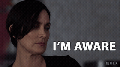A Woman Says I 'M Aware In White Letters GIF