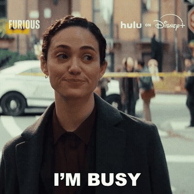 A Woman Says " I 'M Busy " In Front Of A Disney Logo GIF