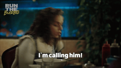 A Woman Says I 'M Calling Him While Sitting At A Table With A Bowl Of Food GIF