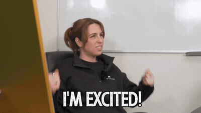 A Woman Says I 'M Excited In Front Of A Whiteboard GIF