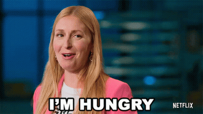 A Woman Says I 'M Hungry In A Pink Jacket GIF