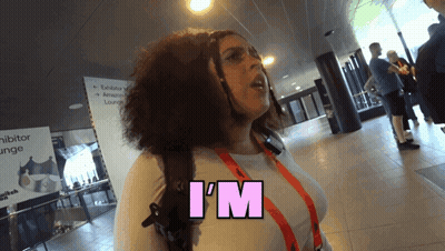 A Woman Says I 'M In Pink Letters On Her Shirt GIF