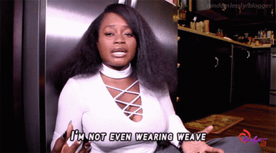 A Woman Says I 'M Not Even Wearing Weave In Front Of A Refrigerator GIF