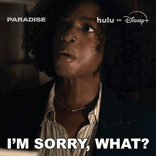 A Woman Says I 'M Sorry What In Front Of A Paradise Advertisement GIF