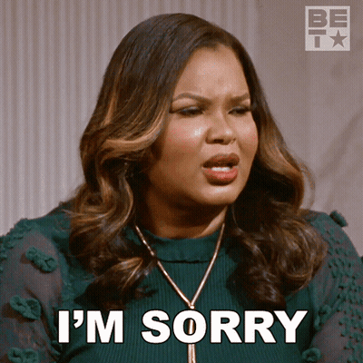 A Woman Says I 'M Sorry While Wearing A Green Shirt GIF