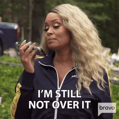 A Woman Says I 'M Still Not Over It While Holding A Cellphone GIF
