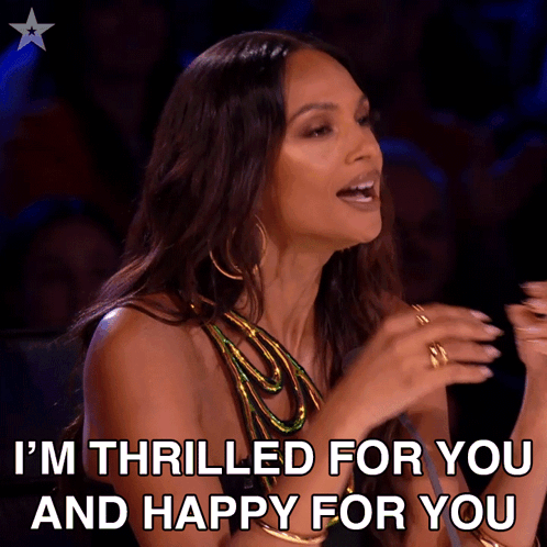 A Woman Says " I 'M Thrilled For You And Happy For You " In Front Of A Microphone GIF