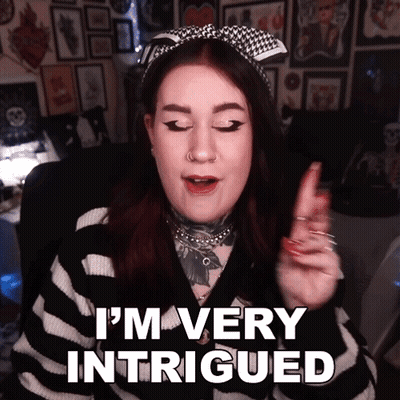 A Woman Says " I 'M Very Intrigued " In A Striped Sweater GIF