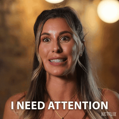 A Woman Says " I Need Attention " In Front Of Her Face GIF