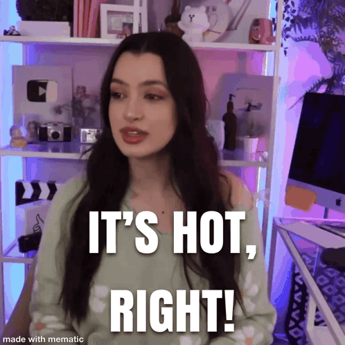 A Woman Says " It 'S Hot Right " While Standing In Front Of A Computer GIF