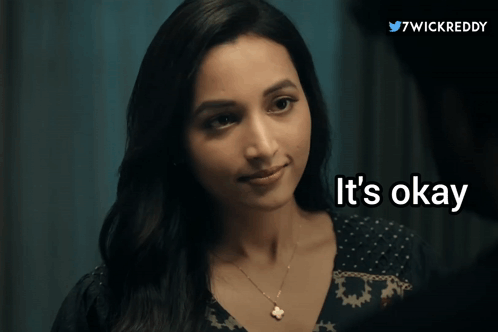 A Woman Says " It 'S Okay " In Front Of A Blue Background GIF