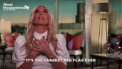 A Woman Says " It 'S The Largest Red Flag Ever " In A Living Room GIF