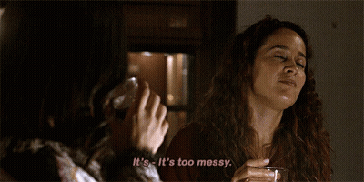 A Woman Says It 'S Too Messy While Holding A Glass Of Wine GIF