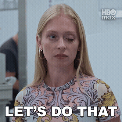 A Woman Says Let 'S Do That In Front Of A White Wall GIF