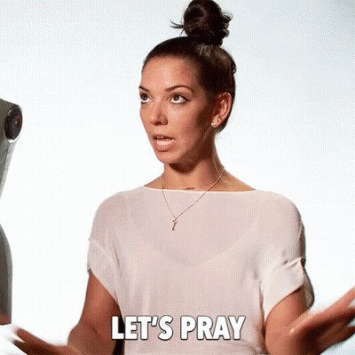 A Woman Says Let 'S Pray While Standing In Front Of A Camera GIF
