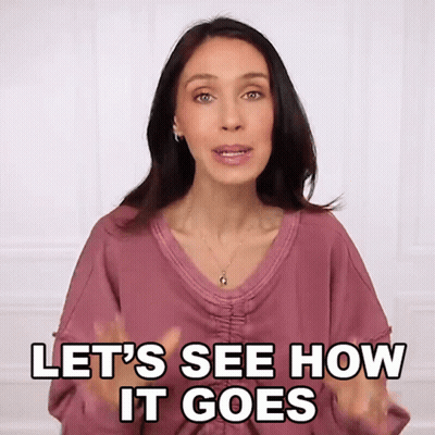 A Woman Says Let 'S See How It Goes With Her Hands In The Air GIF