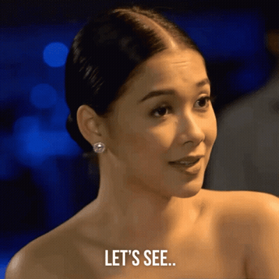 A Woman Says Let 'S See In Front Of A Blurry Background GIF